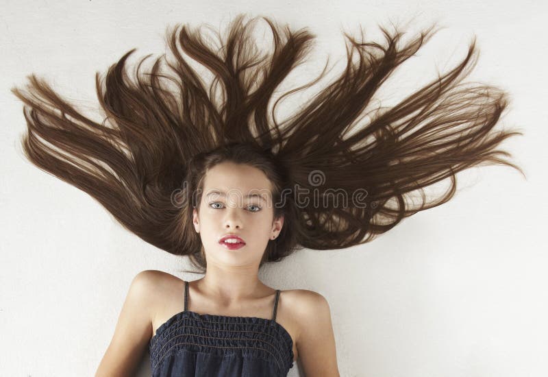 Portrait head shot of a teen girl against a white studio background. Portrait head shot of a teen girl against a white studio background