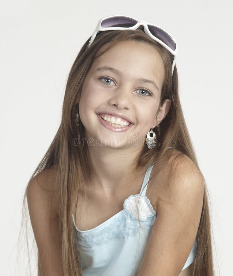 Portrait head shot of a teen girl against a white studio background. Portrait head shot of a teen girl against a white studio background