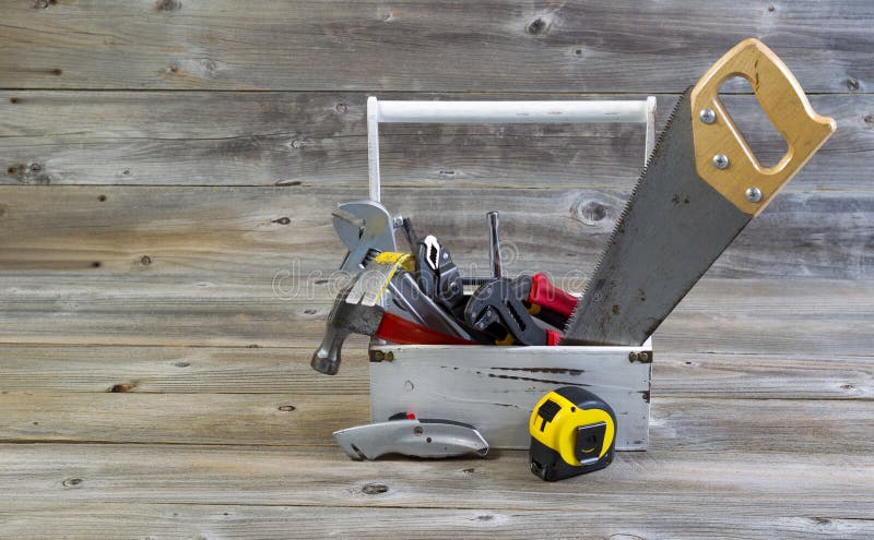 Tool Holder filled with handyman tools on aged wood