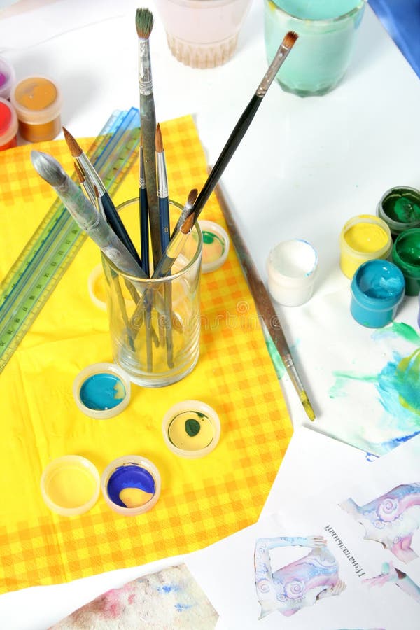 Tools of the artist: paints, brushes and a paper royalty free stock image