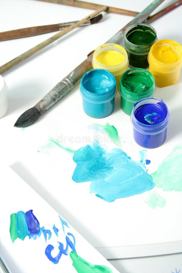 Tools of the artist: paints, brushes and a paper