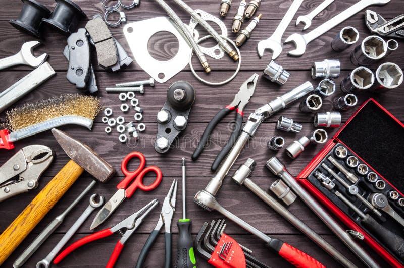 Tools and auto spare parts on wooden workbench