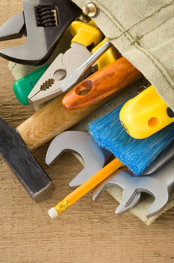 Tools in belt bag on wood