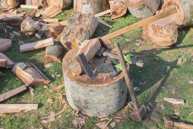 Tools for Chopping Trees. Pile of Firewood Logs and Blocks Stock Photo