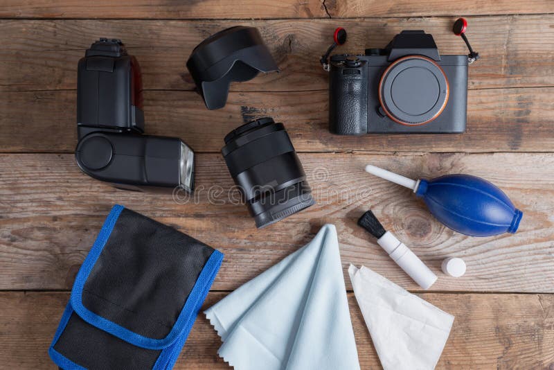 Tools for cleaning camera with dslr camera and lens, flash.