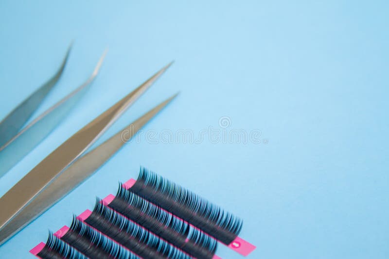 Download Tools For Eyelash Extension Procedure. Two Tweezers With False Lashes On Blue Background ...