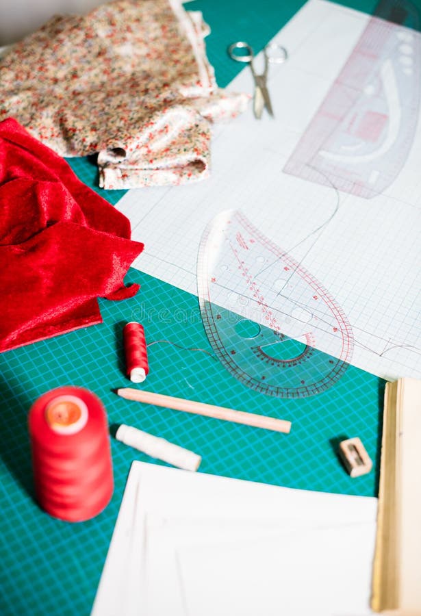 Tools, Patterns and Fabric Samples on the Sewing Table in the Tailor