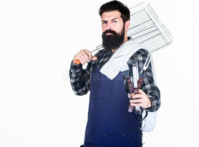 Tools for roasting meat outdoors. Picnic and barbecue. Cooking meat in park. Masculine hobby. Bearded hipster wear apron stock photo Tools for roasting meat outdoors. Picnic and barbecue. Cooking meat in park. Masculine hobby. Bearded hipster wear apron stock photo