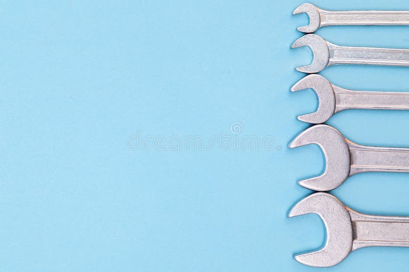 Tools worker, many wrenchs on blue background, top view with free space royalty free stock photo