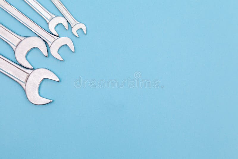 Tools worker, many wrenchs on blue background, top view with free space stock photos