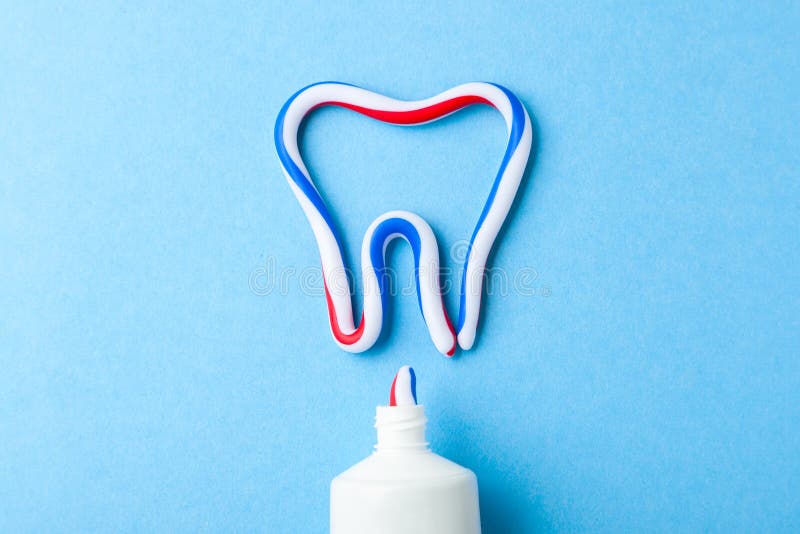 Tooth-paste in the form of tooth. Tube of the paste on blue background. Refreshing and whitening toothpaste.