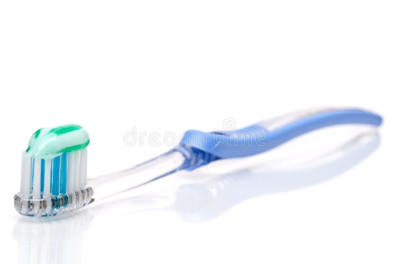 Toothbrush with toothpaste on a white s