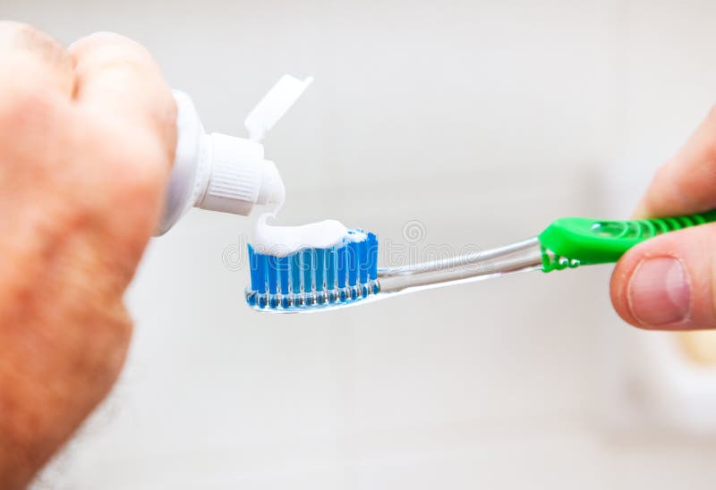 Toothpaste on Tooth Brush stock photo. Image of squeeze 25877012
