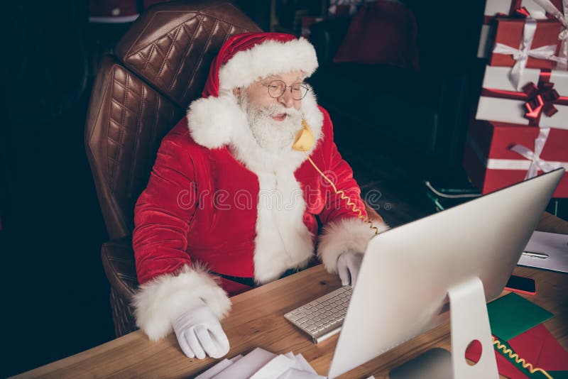 Top above high angle view photo funny grey beard santa claus sit table work computer call telephone deal gift present x royalty free stock image