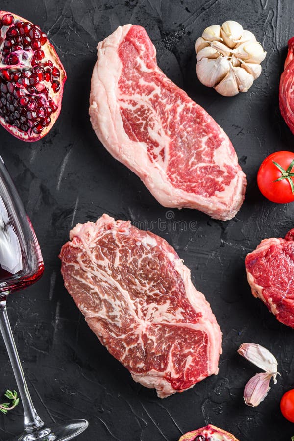 Top Blade, Beef Steak Cuts, with Herbs, Seasoning on Black Table, Top