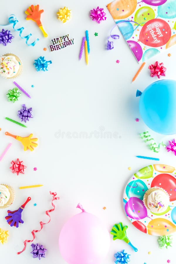 A top down view of birthday party items arranged in a border frame. royalty free stock images