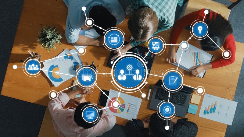 Collaborative Business Meeting with Digital Analytics and Networking Icons Overhead on a Workspace Table Surrounded by royalty free illustration