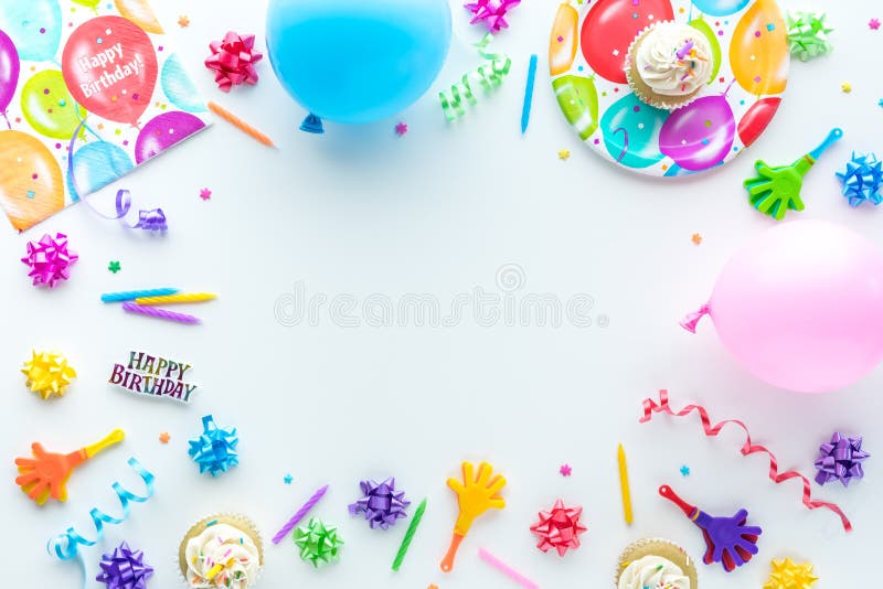 A top down view of common birthday party items in a border frame. stock photo