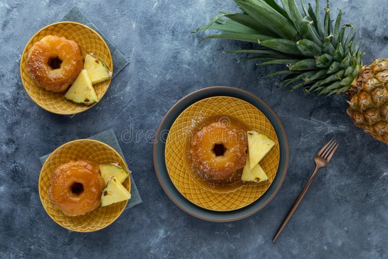 Top down view of servings of pineapple upside down cake and slices of pineapple. royalty free stock photos