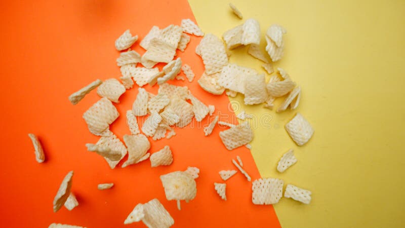 Top down view of snack flying in the air from explosion and falling. Pabulum. stock image