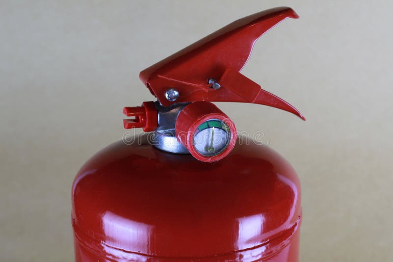 The Top of the Fire Extinguisher the Trigger Lever with a Safety Check and Pressure Gauge Stock