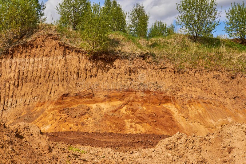 The Top Layer of Earth Dug by the Excavator Bucket for Sand Mining