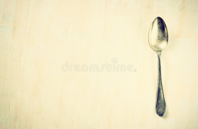 Top view of ancient silver spoon over wooden textured background pic
