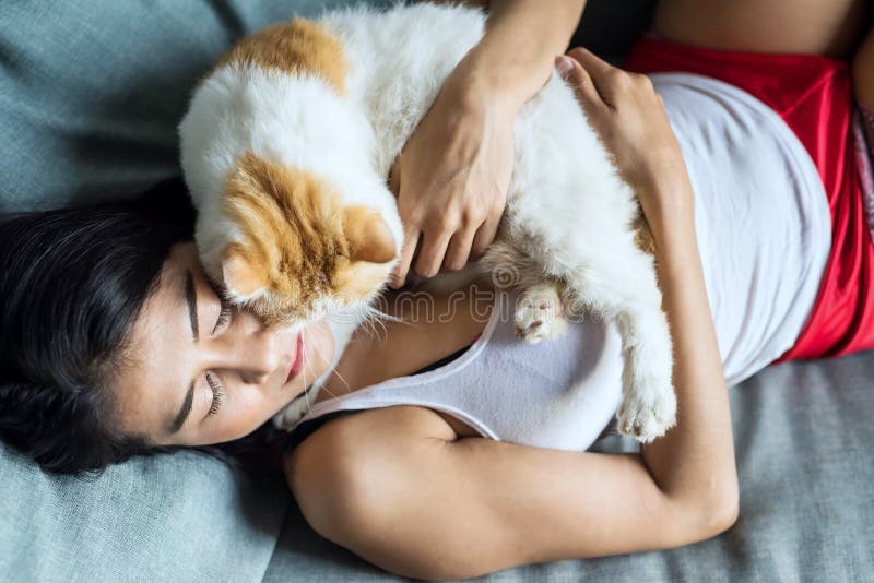 Girl cuddle cat in bedroom stock photo