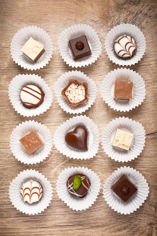 Top view on assorted chocolate pralines on wood