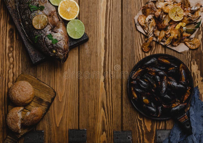 Top View of Assorted Seafood and Baked Fish with Bread Stock Photo