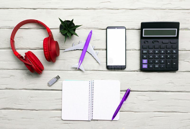 Top view background Musical headphones with a notepad and a calculator, with a pen with a smartphone with a white display for a stock photo
