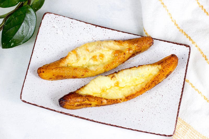 Top view of baked Ripe Plantains with Cheese (Plantain Canoe or Platanos Asados Con Queso) on a plate royalty free stock photo Top view of baked Ripe Plantains with Cheese (Plantain Canoe or Platanos Asados Con Queso) on a plate royalty free stock photo
