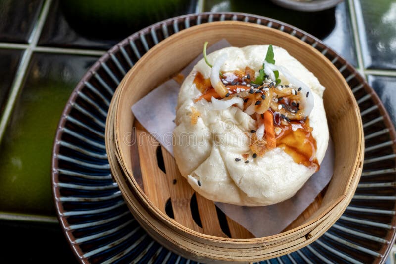 Vietnamese bun with chicken meat, onions and mushrooms serve on bamboo streamer.