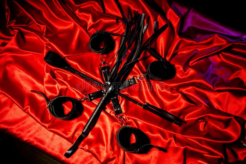 Top View of Bdsm Outfit. Bondage and Whip Crossed Spank on the Red Linen. Sex Games Stock Photo - Image of equipment, sadomasochism: 151056500