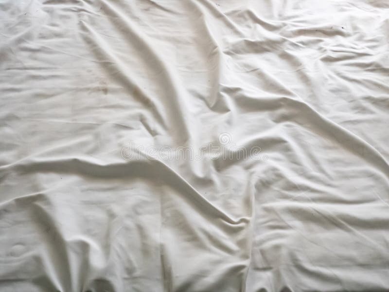 Top View Of The Crease Of An Unmade Bed Sheet In The Bedroom. Stock