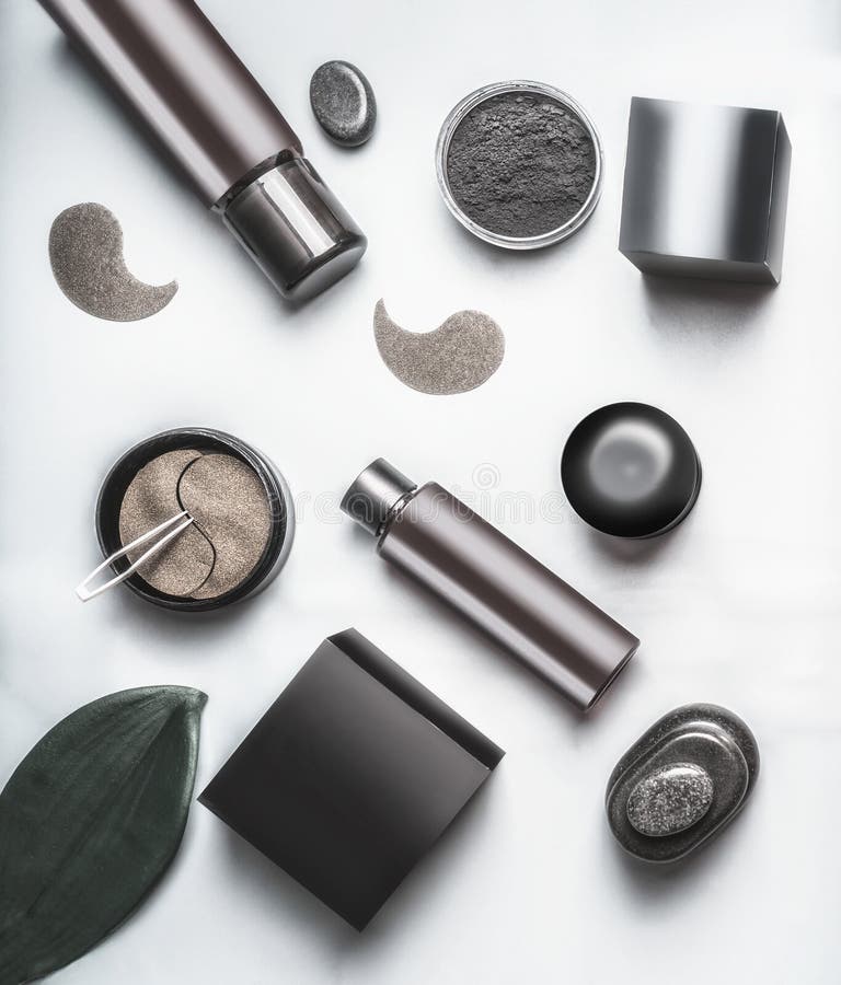 Top view of black and brown packaging of facial cosmetic products. Modern cosmetic set flat lay. Skin care with eye patches and royalty free stock photography Top view of black and brown packaging of facial cosmetic products. Modern cosmetic set flat lay. Skin care with eye patches and royalty free stock photography