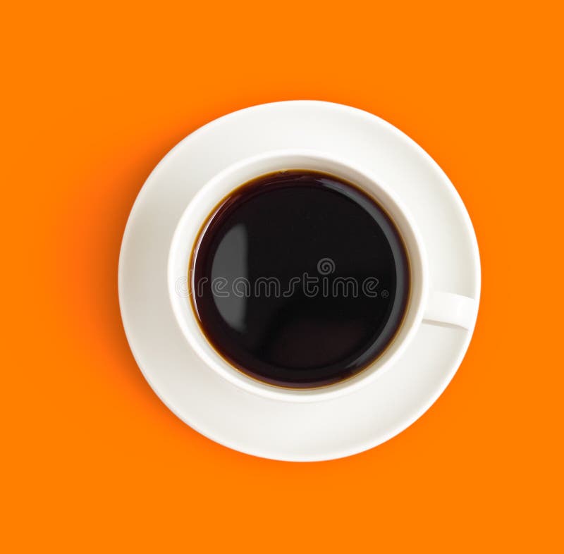 Top view of black coffee cup on orange