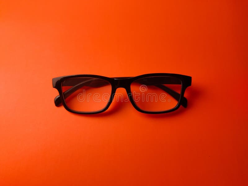 Top view black glasses on a orange background stock photography