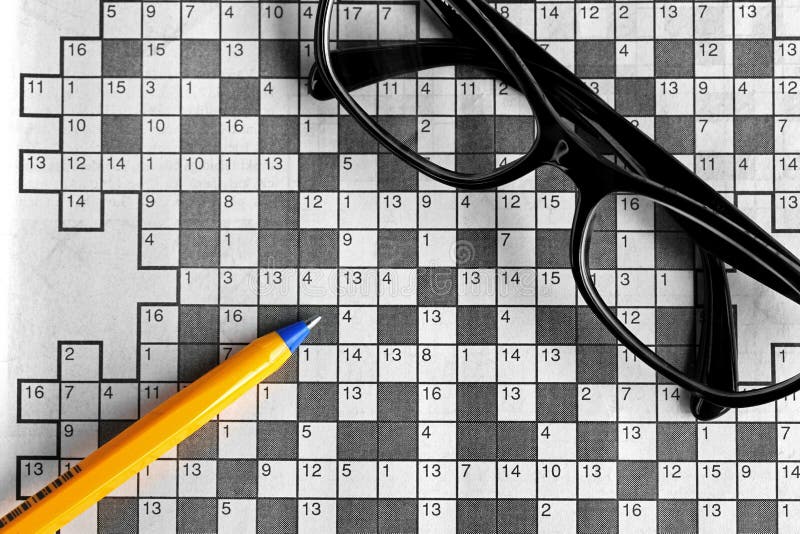 Top View of Blank Crossword Puzzle with Eyeglasses and a P Stock Photo