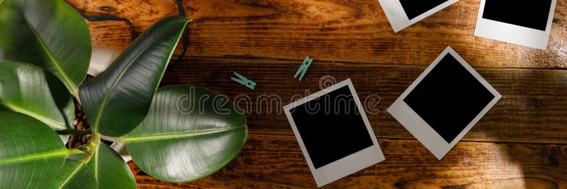 Top view of blank photographs next to a camera on a wooden table. The concept of pleasant memories. Banner royalty free stock photo Top view of blank photographs next to a camera on a wooden table. The concept of pleasant memories. Banner royalty free stock photo