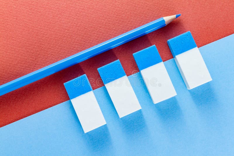 Top view of blue pencil and erasers on color papers royalty free stock photos