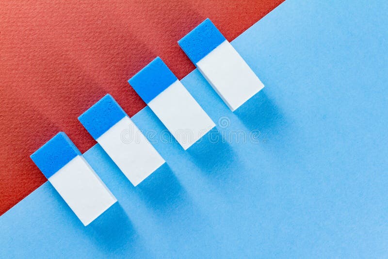 Top view of colorful erasers on color papers placed diagonally royalty free stock image