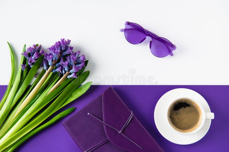 top view of bouquet of purple hyacinth flowers and cup of coffee