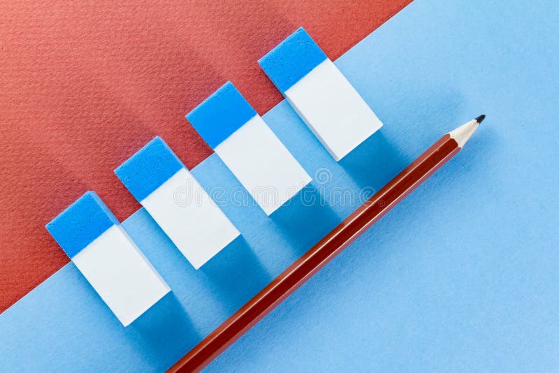 Top view of brown pencil and erasers on color papers stock images
