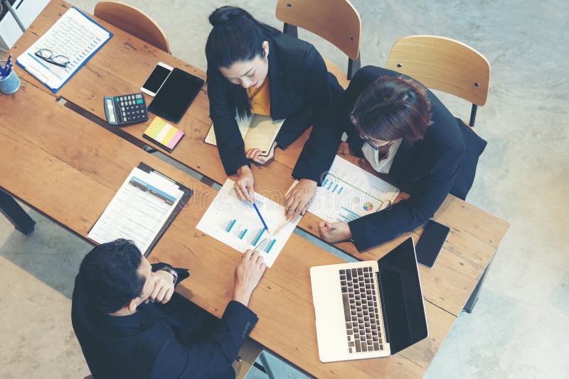 Top view business partners training and discussing contract and graph of financial report development. stock images Top view business partners training and discussing contract and graph of financial report development. stock images