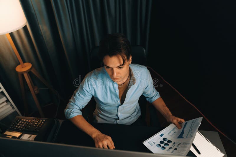 Top view businessman analyzing business paragraph marketing analysis. Pecuniary. Top view smart businessman analyzing business paragraph dynamic database marketing analysis plan surrounded paper sheet, pc monitor report to compare with document data at home office.