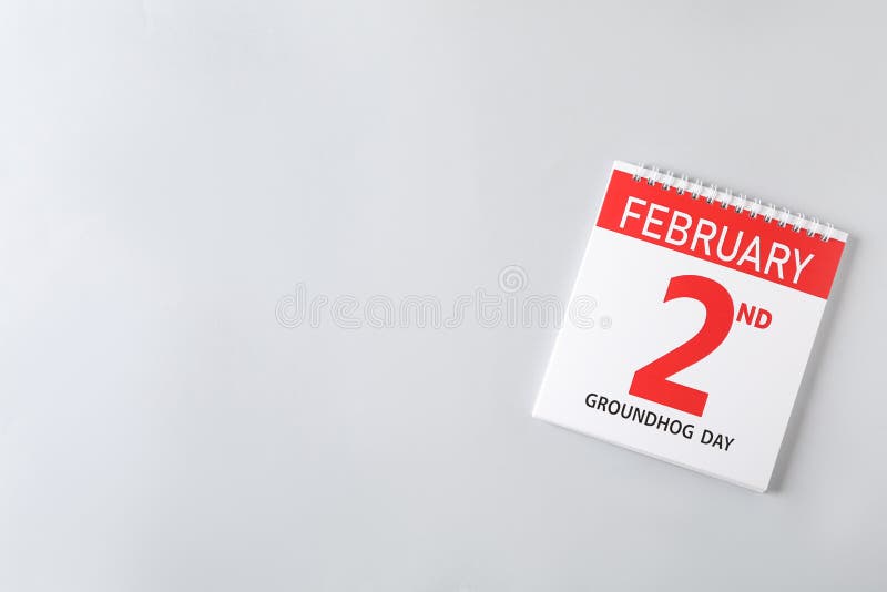 Top view of calendar with date February 2nd on light background, space for text. Groundhog day