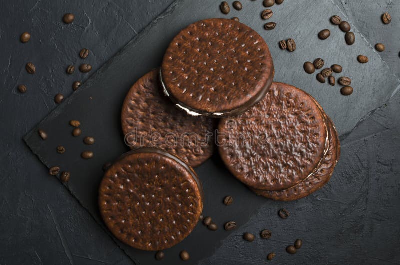 Top view of chocolate biscuits, coffee beans on the black table. Coffee and chocolate taste royalty free stock images