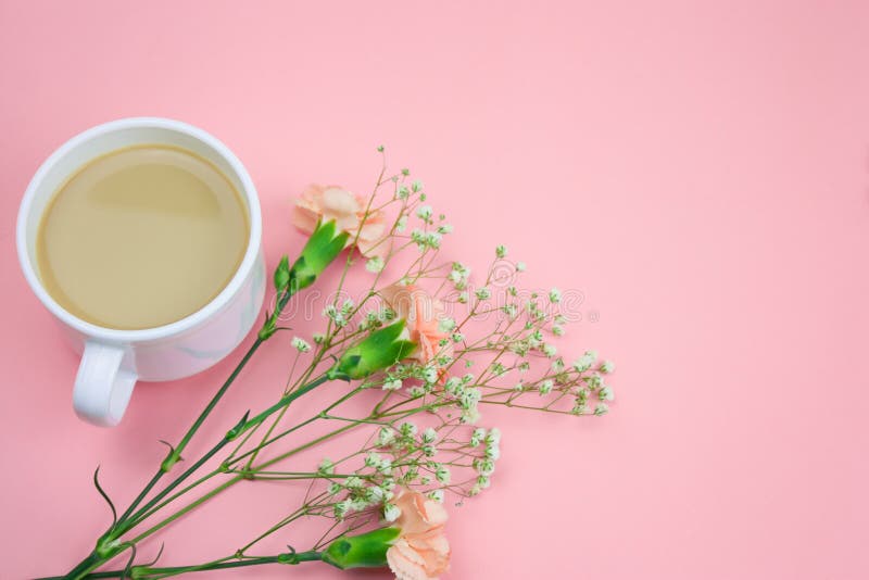 Coffee with Cream Cup, Notebook,pencils and Pink Gift Box with Flowers Frame on a Blue