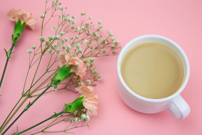 Coffee With Cream And Flowers On A Pastel Pink Background Stock Image